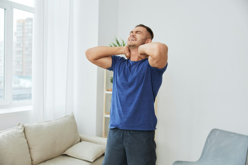 Man back neck and shoulder pain, inflammation of muscles and ligaments rupture during sports